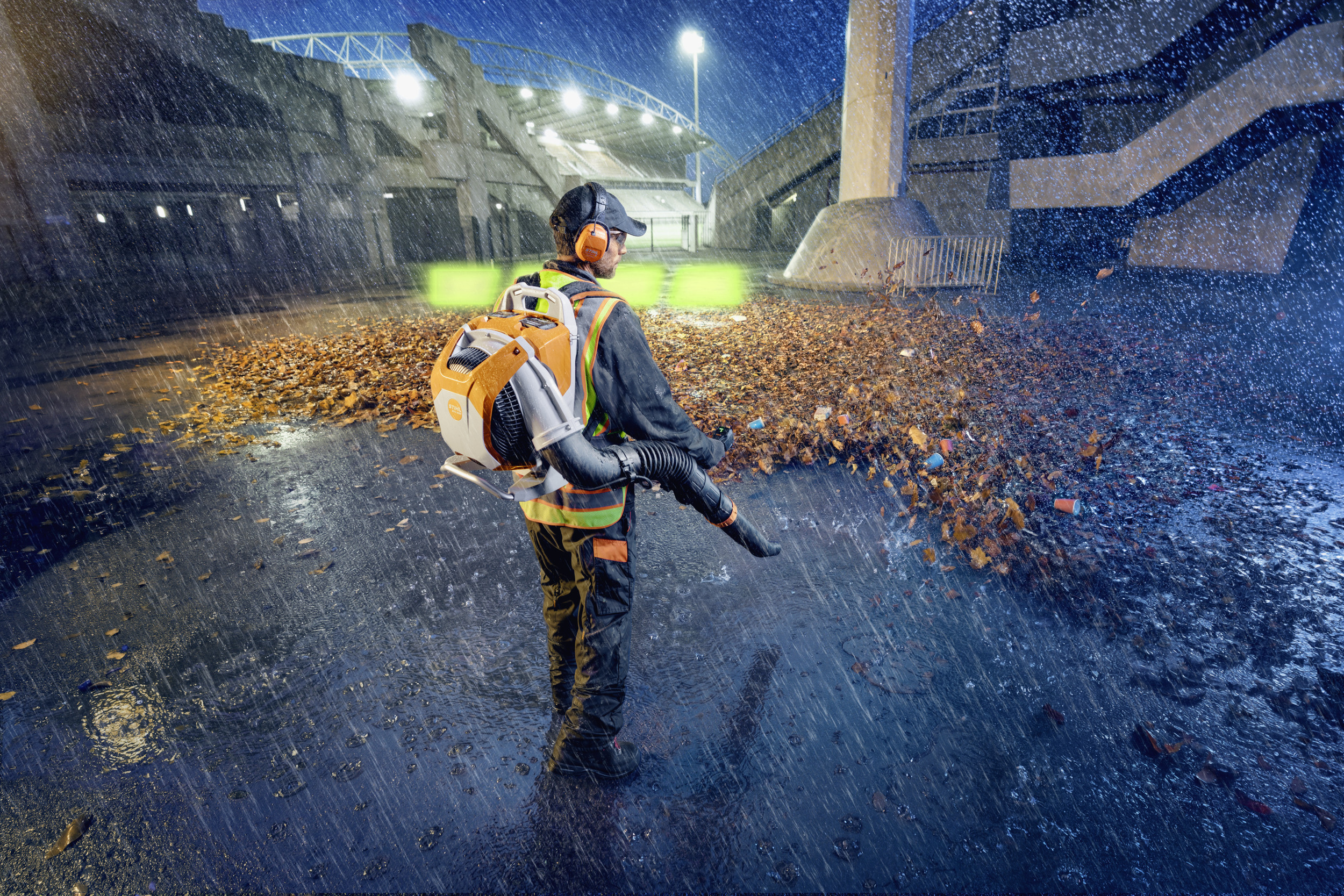 A man is blowing wet leaves off the tarmac with the BRA 600 